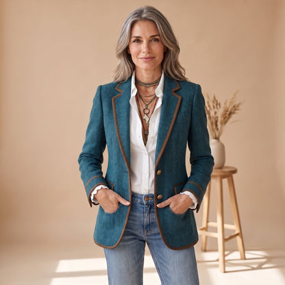 Model draagt de getailleerde blazer over een witte blouse